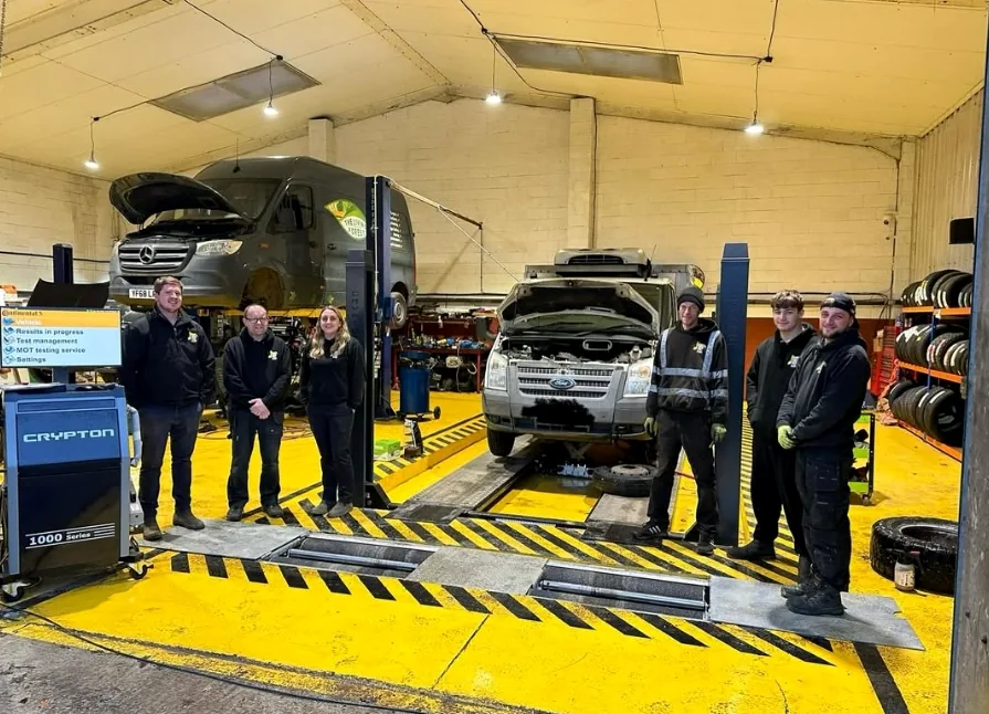 The Top Plant Garage team standing together inside their Robertsbridge workshop
